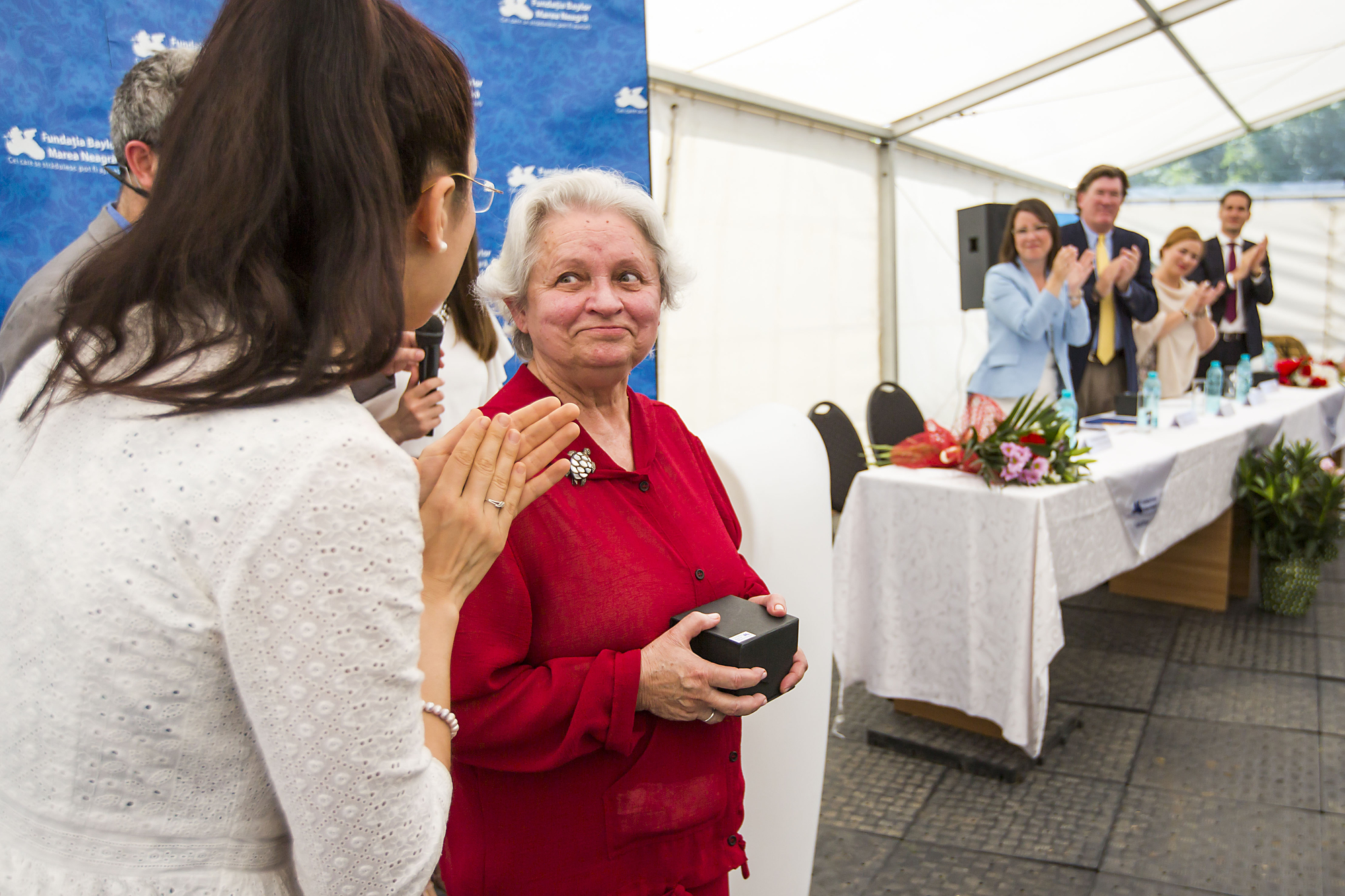 Ana-Maria Schweitzer, Executive Director, Romania, applauds Dr. Rodica Matusa, who receives a standing ovation during a celebration of the opening of the expansion of the Baylor Black Sea Foundation Center of Excellence on Tuesday, June 7, 2016, in Constanta, Romania. ( Photo by Smiley N. Pool / © 2016 )