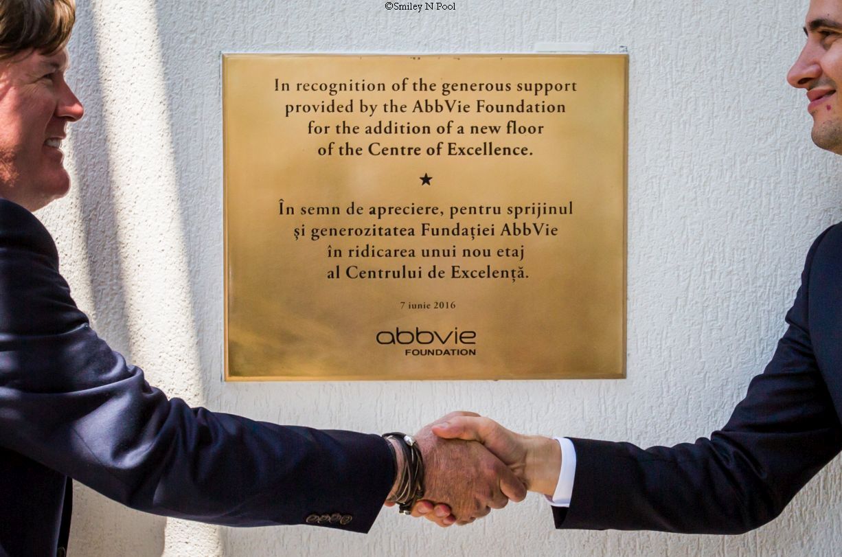 Mizwa, COO of the Baylor International Pediatric AIDS Initiative and director Texas Children's Global Health, shakes hands with the vice mayor of Constanta during a celebration of the opening of the expansion of the Baylor Black Sea Foundation Center of Excellence on Tuesday, June 7, 2016, in Constanta, Romania. ( Photo by Smiley N. Pool / © 2016